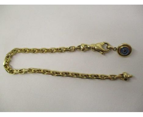 An Adler gold coloured metal, chain link bracelet set with a blue and black glass bead pendant, 7 1/2"l, 21.8g 