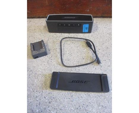 A Bose Soundlink mini Bluetooth speaker, grey with USB charging lead 