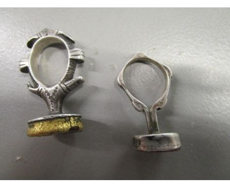 A white metal and yellow metal Sudanese seal ring set with an agate and a similar smaller white metal seal ring set with a re