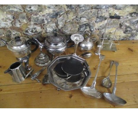 A selection of silver plate to include a teapot, a ladle and other items 