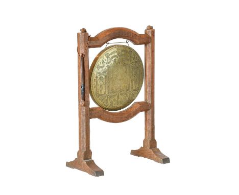 Robert Mouseman Thompson (1876-1955): An English Oak Dinner Gong, circa 1934, with an Egyptian circular engraved brass gong s