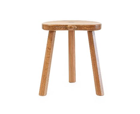 Workshop of Robert Mouseman Thompson (Kilburn): An English Oak Kidney Shaped Calf Stool, on three octagonal legs, with carved