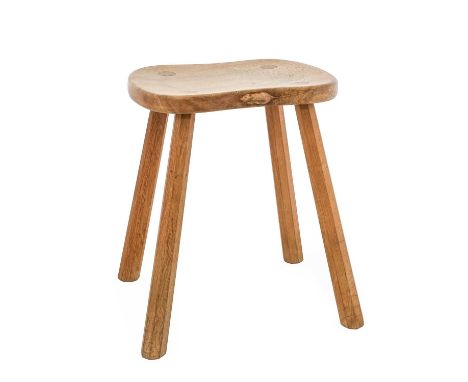 Workshop of Robert Mouseman Thompson (Kilburn): An English Oak Cow Stool, with shaped seat, on four octagonal legs, with carv