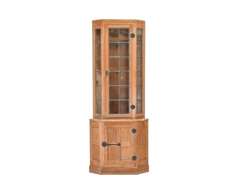 Workshop of Robert Mouseman Thompson (Kilburn): An English Oak Corner Display Cupboard, the upper section with leaded glazed 
