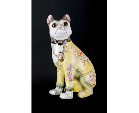A Continental Pottery Model of a Seated Dog in the Manner of Émile Gallé, circa 1900, wearing head scarf and a yellow coat tr