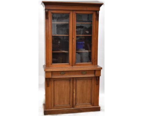 A 19th century mahogany break-front chiffonier bookcase, the top comprising a pair of glazed doors enclosing three adjustable