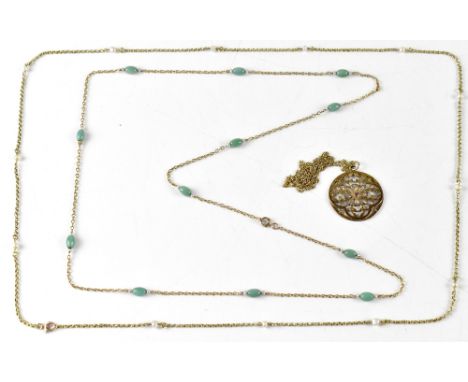 A 9ct gold dainty necklace with unmarked yellow metal circular pendant with central ruby in star mount within openwork leaves