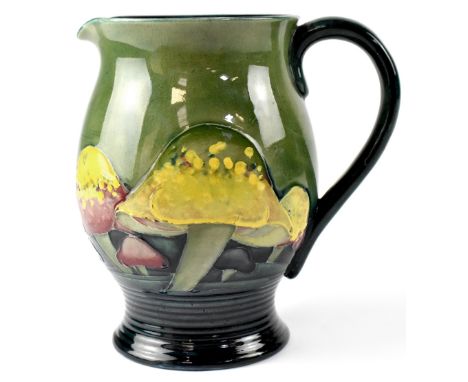 WILLIAM MOORCROFT; a 'Claremont' pattern baluster shaped jug with yellow and red toadstools on a green and blue ground, with 