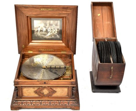 A 19th century walnut tabletop polyphon, the horizontal movement playing steel discs, the hinged lid with marquetry inlaid fl