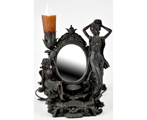 A decorative table lamp in the Art Nouveau style, central mirror and figures to either side, to a shell and floral base, heig