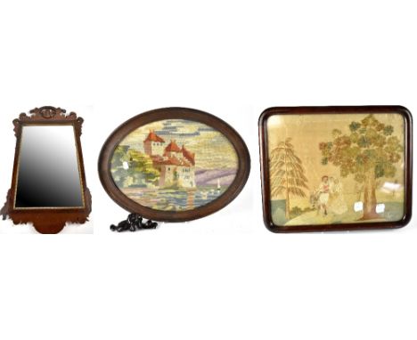 A 19th century mahogany fretwork framed mirror, 80 x 46cm (af), an Edwardian oval woolwork tapestry of castle on a hill, with