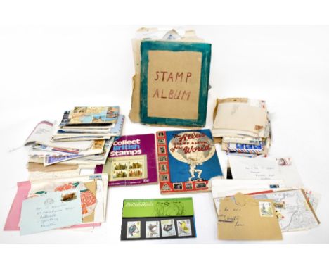 A large quantity of loose stamps, a home-made stamp album and various first day covers.