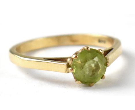 A 9ct gold ring with claw set single peridot, size K, approx 1.6g.
