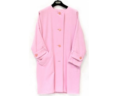 A Celine of Paris bubble-gum pink collarless coat, four buttons with pockets to either side. 