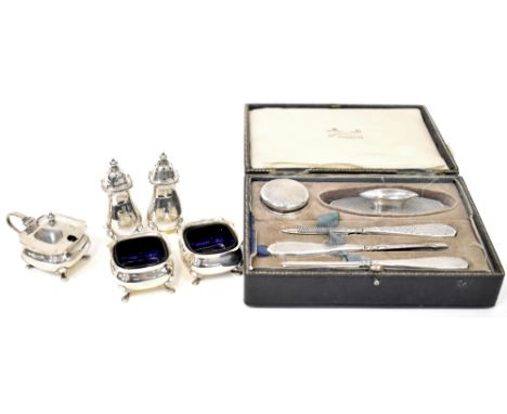 A George VI hallmarked silver five-piece cruet set with blue glass liners together with a vintage cased manicure set comprisi