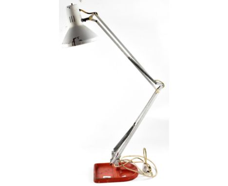 A vintage white metal Anglepoise lamp on a red cast iron industrial-style stand.