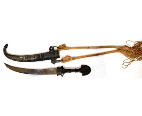 An antique Persian/Turkish steel jambiya dagger with curved blade, shaped wooden handle with crescent-shaped top, white metal