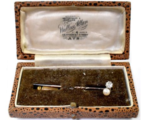 A diamond and pearl scarf pin, the claw set small brilliant approx. 0.25ct, mounted next to a small seed pearl on yellow meta