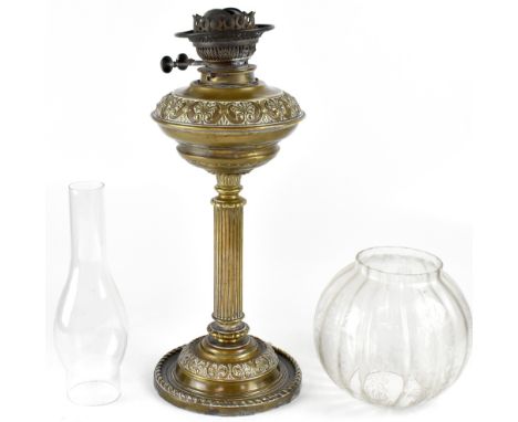 An Edwardian brass oil lamp with scroll decorated oil reserve, Corinthian column to circular spreading base, clear etched gla