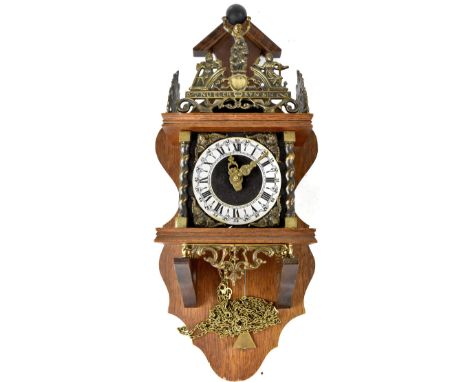 An early/mid-20th century German oak chiming clock, pediment top and brass figure of Atlas holding aloft the world, three bra