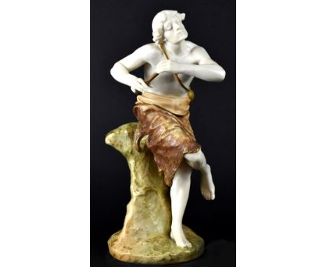 ROYAL WORCESTER; a seated figure of a shepherd wearing a loincloth, holding a gilded water bottle and carrying a staff, on a 