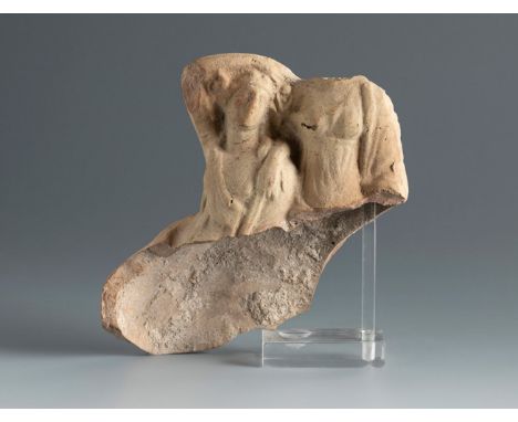 Fragment of a statuette showing Dionysus with a maenad. Smyrna, 3rd century BC.Terracotta.Provenance: Smyrna, 1895-1905. Coll