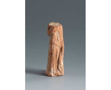 Headless female figure holding a chiton. Smyrna, 4th-3rd century BC.Terracotta.Provenance: Smyrna, 1895-1905. Collection Paul