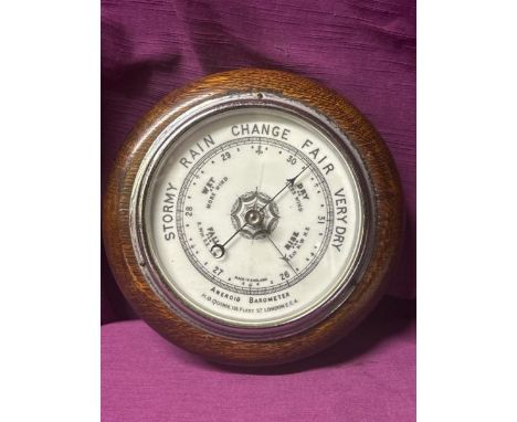 A small mahogany anaroid barometer by H.O. Quinn. 18cm diameter   / All lots are located at The Barn, Hampstead Farm, Nr Henl