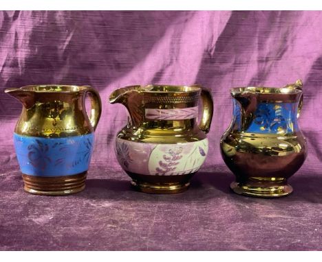 Three similar vintage copper glazed, hand painted jugs, largest 10cm (h)  / All lots are located at The Barn, Hampstead Farm,