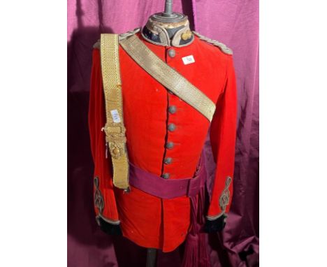 Victorian British military dress tunic from in bright red with gold braid detailing and decorative buttons. It comes with a c