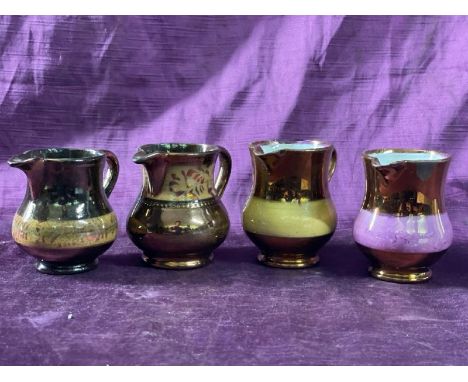 Four similar vintage copper glazed jugs, largest 8cm (h)  / All lots are located at The Barn, Hampstead Farm, Nr Henley on Th