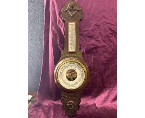 An oak cased aneroid barometer, 72cm high, 17cm diameter   / All lots are located at The Barn, Hampstead Farm, Nr Henley on T