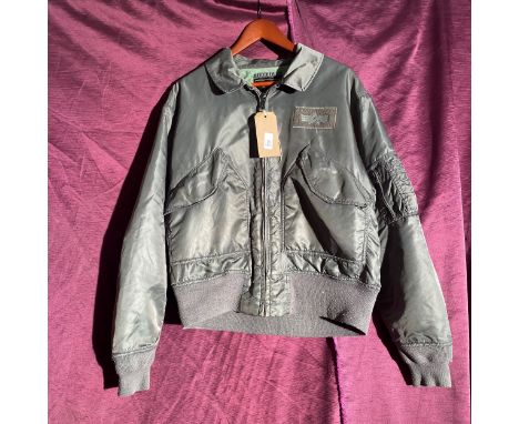 Alpha Industries flight jacket, size Medium. This item features a front zipper and multiple pockets   / All lots are located 