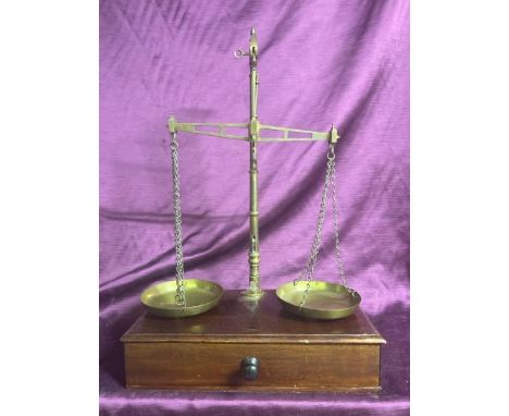 Brass scales by W&T Avery on a wooden base with drawer. Measures 56cm high  / All lots are located at The Barn, Hampstead Far