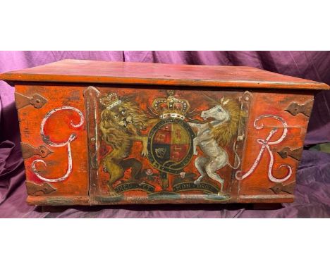A 19th century oak metal banded trunk with GR sypher and hand painted coat of arms applied in old red paint (possibly a movie