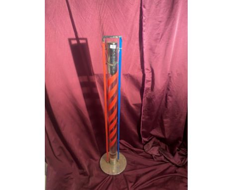 Vintage barbershop pole with red and blue spiral stripes encased in a transparent cylinder. It has a chrome base and top   / 