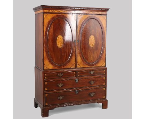 probably Channel Islands, the dentil cornice and interlacing border inlay over cupboard doors with corner fan and central pat
