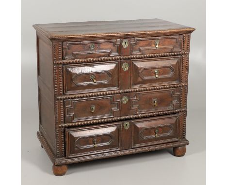 the four graduated drawers with geometric and beaded moulding, brass drop handles and bun feet, height 94cm, width 100cm, dep