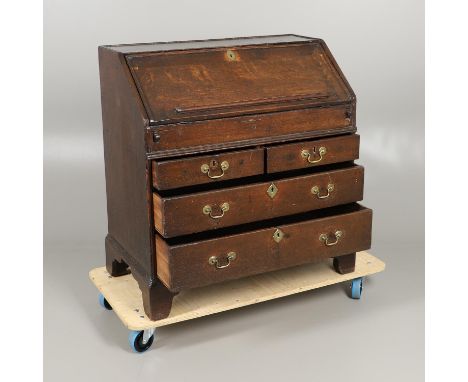 the fall front enclosing a pigeon hole compartment with four drawers and central covered well, over two short and two drawers