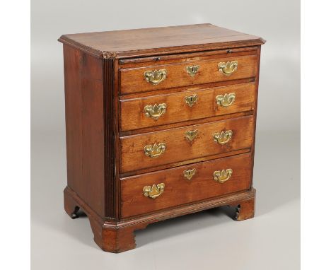 with brushing slide over four graduated drawers, flanked by fluted canted corners upon bracket feet, height 83cm, width 81cm,