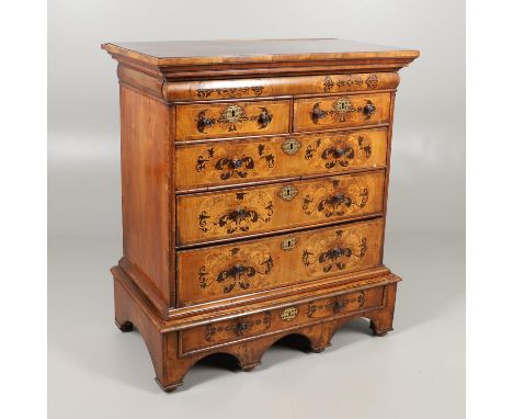 the seven drawers inlaid with foliate and bird detail upon an multi-arched stand and turned bun feet, height 116cm, width 103