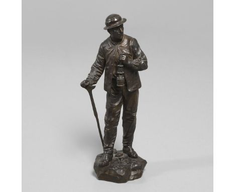 a patinated bronze study of a miner carrying a lamp, on a naturalistic rocky base signed 'Bouret' and with a title plaque to 