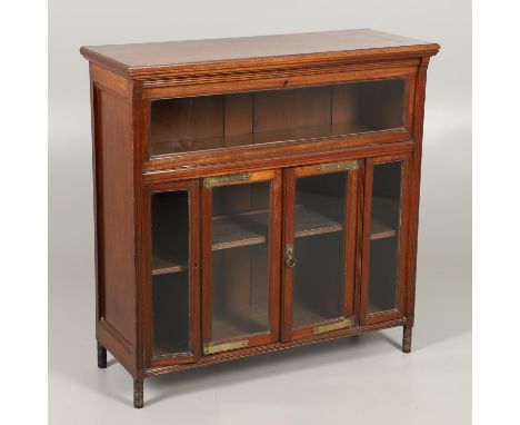 in the Aesthetic style, with pull-down top section above a pair of cupboard doors with brass mounts flanked by two further na