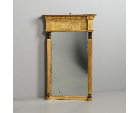 19th century, the ball studded frame above a fish scale panel, flanked by ebonised Sphinx heads and paw feet on reeded column