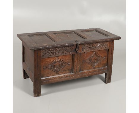 the panelled top with iron latch enclosing a vacant interior with open candlebox, the front with frieze and twin panels carve