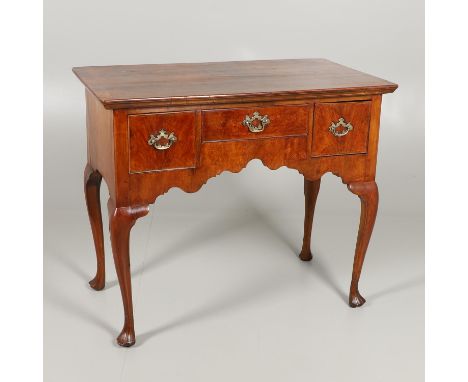 the satinwood strung top over three drawers and arch shaped apron, on cabriole legs and carved triform feet, height 82cm, wid