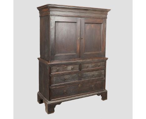 the upper section with cupboard doors enclosing a pigeon hole interior with secret drawers behind, with a further arrangement