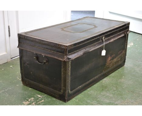A Spanish leather and camphor rectangular travelling trunk, applied throughout with bands of brass studs, hinged cover, loop 