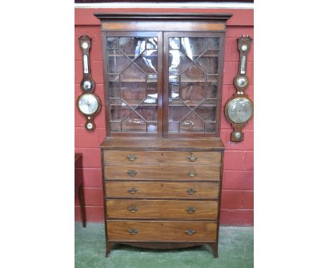 A George III mahogany secretaire bookcase, stepped cornice above a satinwood veneered frieze and a pair of astragal glazed do