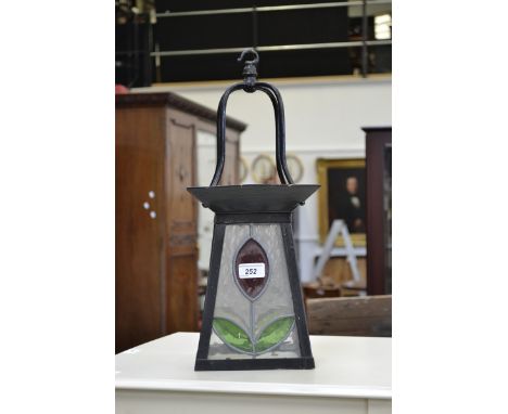 A wrought iron and stained glass porch lantern.
